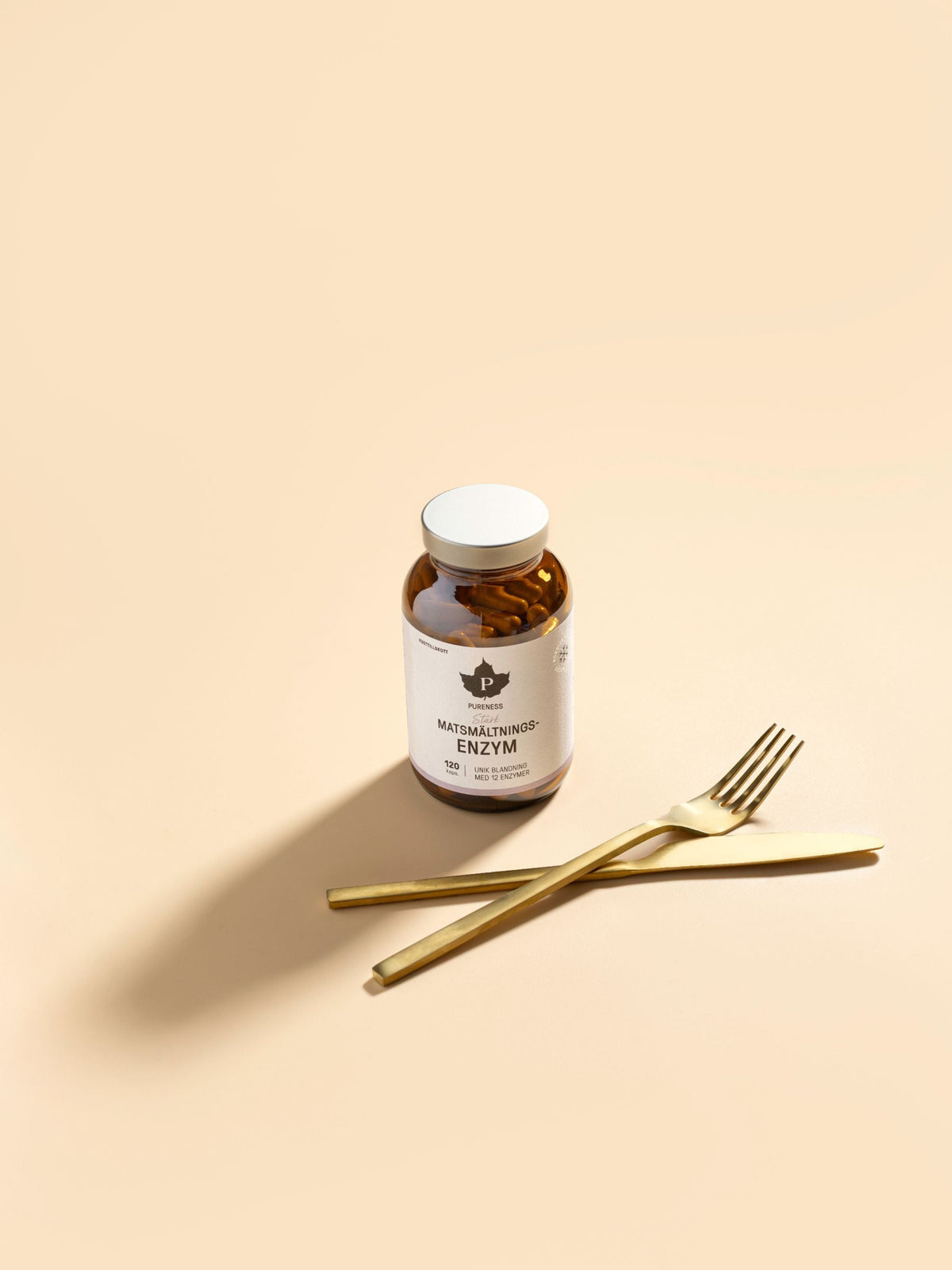 en burk pureness stark matsmältningsenzym med en kniv och gaffel som ligger framför